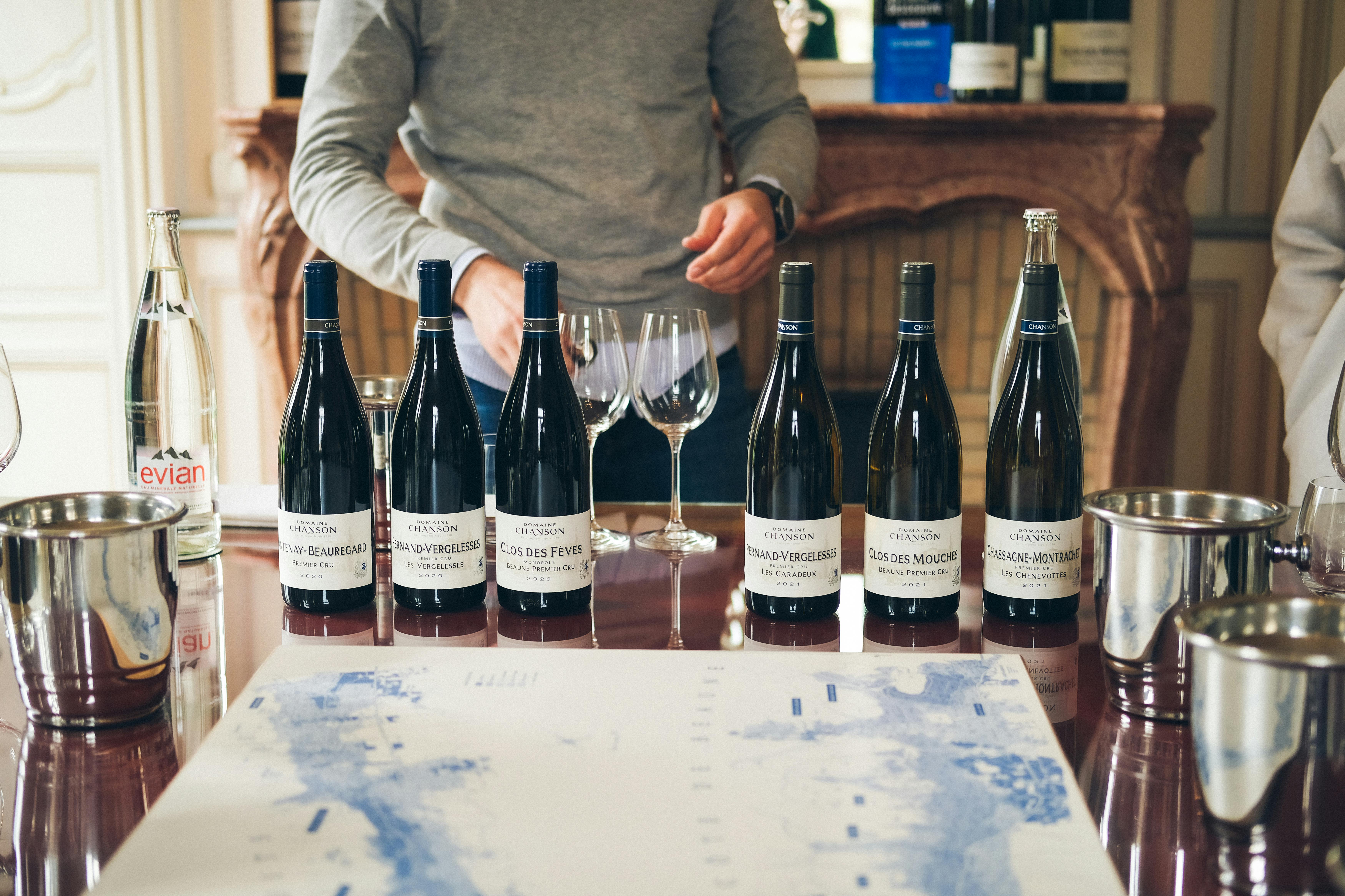 a wine tasting experience with bottles of red wine on the table